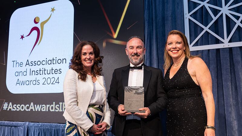 Angela Guillemet, awards judge, presents the best membership services awards to David Farrelly and Louise Keegan, Learnovate