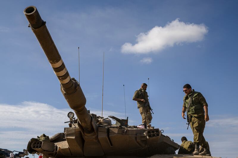 Israeli soldiers on a tank near Be'eri, a kibbutz near the border with the Gaza Strip, in Israel. Photograph: Tamir Kalifa/New York Times
                      