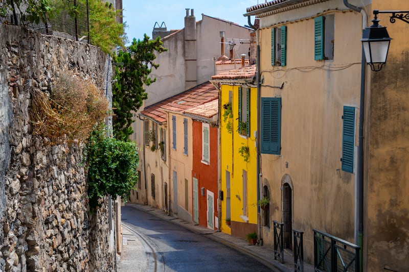 Colorful facades of ancient houses in a street in the old town of Hyères,  in the French department of Var. Photograph: HJBC/Getty Images/iStockphoto