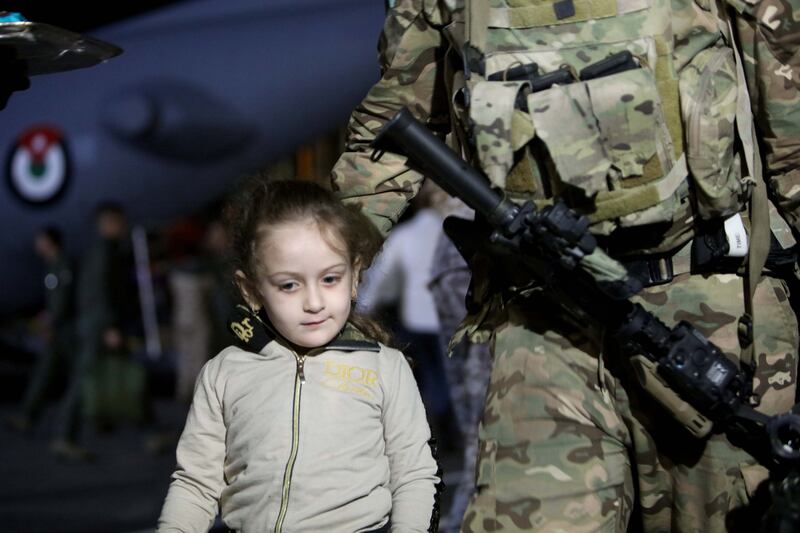 A child from a group of 343 citizens of Jordan, Palestine, Iraq, Syria, and Germany who were evacuated from Sudan disembarks from military aircraft at Marka Military Airport, in Amman, Jordan, 24 April 2023. Heavy armed clashes between the military and rival paramilitay groups have been occurring in Khartoum and other parts of Sudan since 15 April 2023.