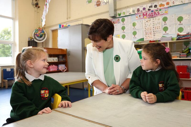 Norma Foley with Aodha Hayden (right) and Ellie Mai Moore, junior infants from St Kevin's National School in Littleton Co Tipperary. Photograph: Damien Eagers