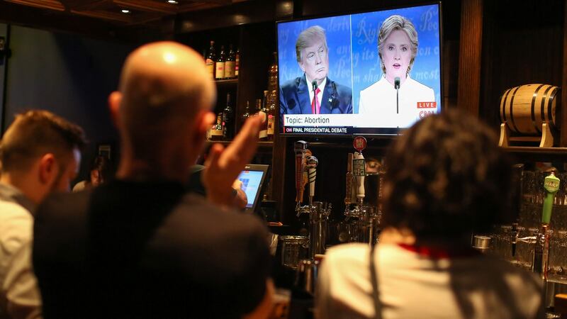 People watch the third presidential debate between presidential debate between US Democratic presidential candidate Hillary Clinton and US Republican presidential candidate Donald Trump at Murphy’s Tap House in  Charlotte, North Carolina. Photograph:  Logan Cyrus/AFP/Getty Images