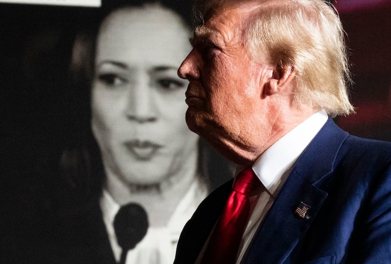 Donald Trump waits as a campaign video plays behind him during a rally at the Expo at World Market Center in Las Vegas. Photograph: Doug Mills/The New York Times
                      