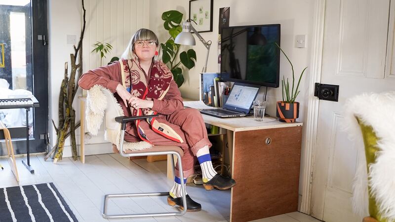 Irenie sits at the family’s WFH desk, made by Trevor by repurposing old materials.