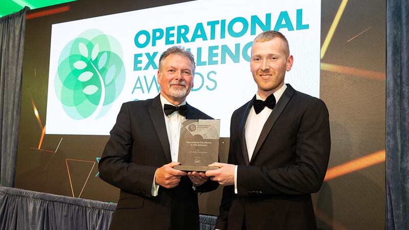 Sean Mc Auliffe, director of specialised services at ISS Ireland, presents the operational excellence in life sciences to Neil Wall, community director at Business River in behalf of APC & VLE Therapeutics