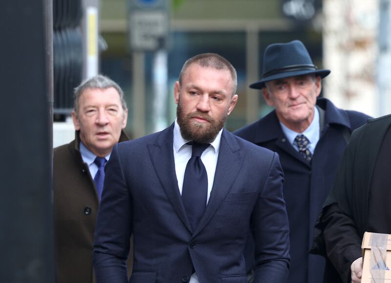 Tony McGregor, solicitor Michael Staines and MMA fighter Conor McGregor arriving at the High Court on Tuesday. Photograph: Collins Courts
