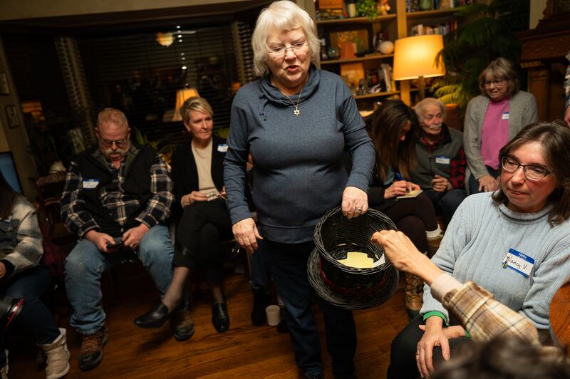 Mayor Sharon McNutt collects votes from caucus-goers at her home during the state's only living-room-based caucus in Silver City, Iowa. Photograph: Vincent Alban/New York Times