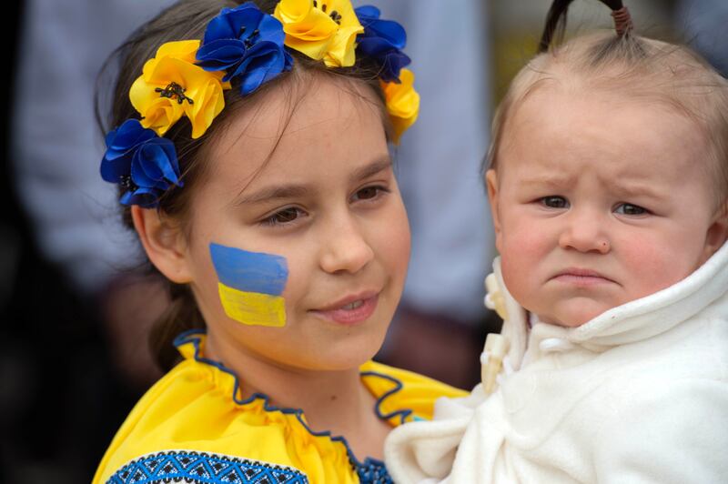 Polina Kzemenchyc takes care of her niece Sofia as Cork’s Ukrainian community attend the Vyshyvanka Day rally. Photograph: Michael Mac Sweeney/Provision