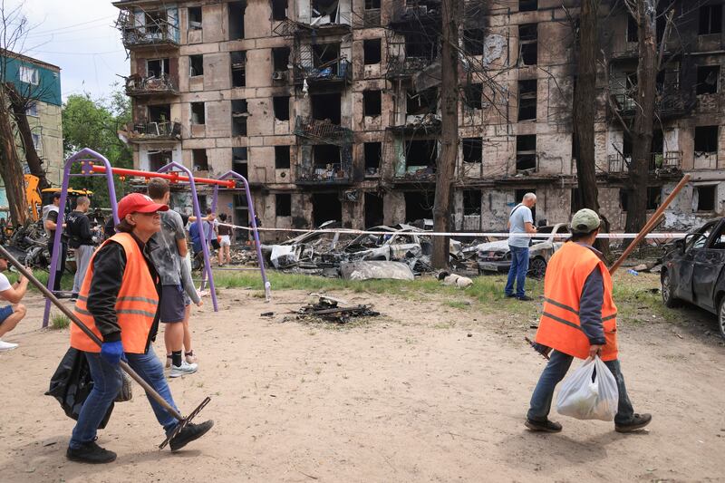 Municipal workers clean up near the site of a Russian rocket attack in Kryvyi Rih. Photograph: Andriy Dubchak/AP