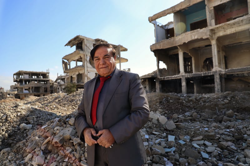 Khalid Khalif (65) surveys the pile of rubble strewn in front of the crumbling structure that once housed his family’s home in Yarmouk. Photograph: Hannah McCarthy