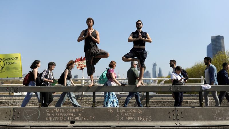 Climate change activists practise yoga on Waterloo Bridge  in London. Photograph: Simon Dawson/Reuters