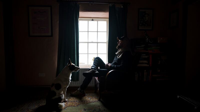 Cathal McNaughton his home in Waterfoot along side his dog Murphy. Photograph: Charles McQuillan