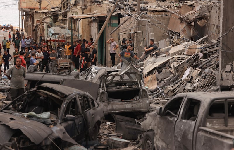 Palestinians inspect the destruction in a neighbourhood heavily damaged by Israeli airstrikes on Gaza City's Shati refugee camp. Photo Mahmud Hams/AFP via Getty Images