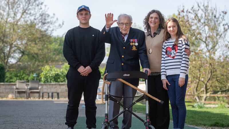 Captain Tom Moore, with (left to right) grandson Benji, daughter Hannah Ingram-Moore and granddaughter Georgia. File photograph: PA