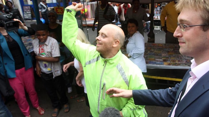 A man throws egss at Labour leader Ed Miliband during a campaign visit in East Street market in Walworth, south London. Photograph: Lewis Whyld/PA Wire.