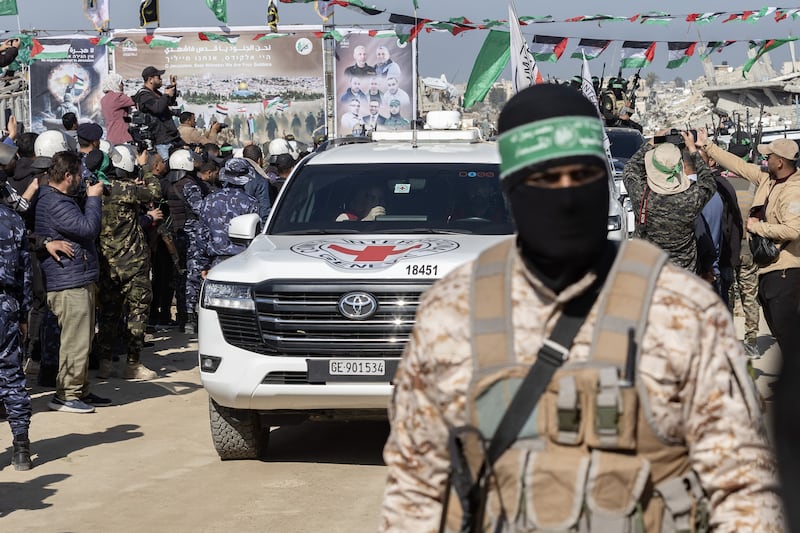 Palestinian fighters escort three Israeli hostages to a Red Cross team in Khan Younis, in the southern Gaza Strip, on Saturday. Photograph: Saher Alghorra/New York Times