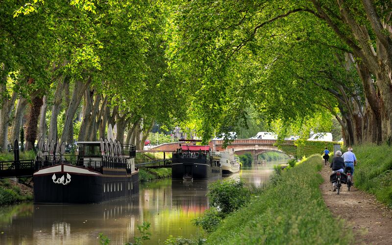 Cycling the towpath along the Canal Du Midi, Toulouse, France. Photograph: iStock