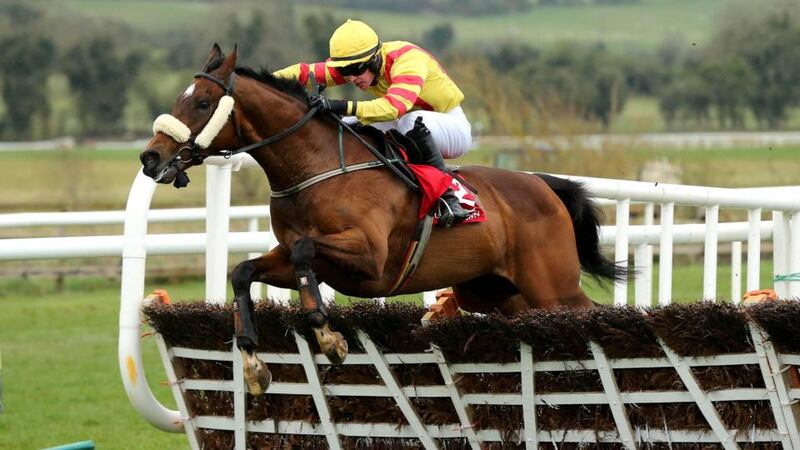 Jockey David Splaine on Beau Michael clears the last hurdle to win the first race of the day at Punchestown. Photograph: Cathal Noonan/Inpho