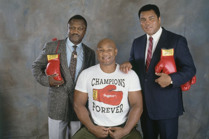 George Foreman poses with Muhammad Ali and Joe Frazier in October 1989. Photograph: Micheline Pelletier/Sygma