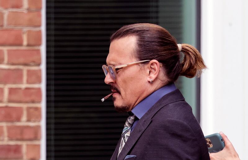  Actor Johnny Depp smokes during a break in his trial at the Fairfax County Courthouse. Photograph: Kevin Dietsch/Getty Images