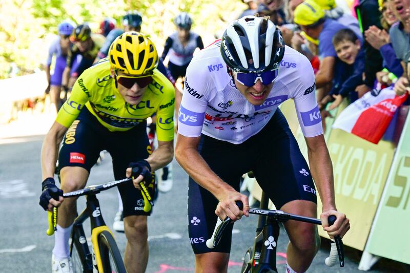 Tadej Pogacar wearing the best young rider's white jersey cycles ahead of Jumbo-Visma's Danish rider Jonas Vingegaard in the final ascent of Col du Grand Combier late in the 13th stage  of the Tour de France. Photograph: Bernard Papon/Pool/AFP/Getty Images