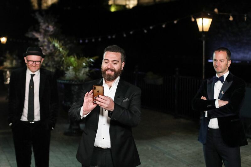 Paul Young, from left, Tomm Moore and Ross Stewart watch a live link of the Oscars as the winner of the category Animated Feature Film is announced on Monday, April 26, 2021 in Kilkenny, Ireland. (AP Photo/Peter Morrison, Pool)