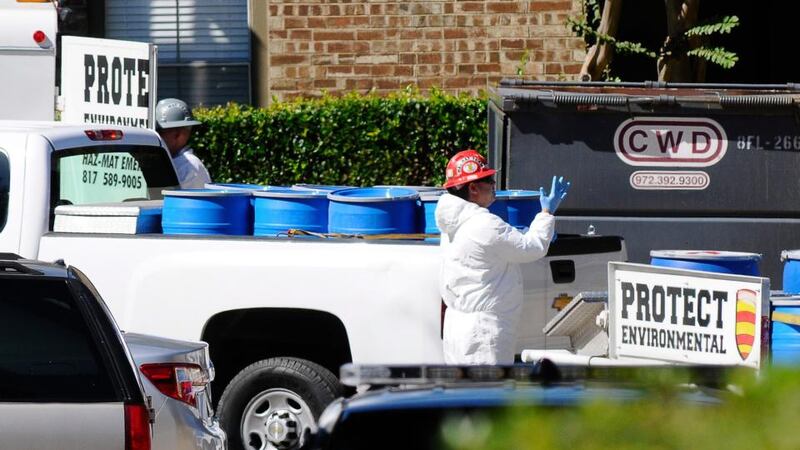 Containment barrels are carried into the Village Bend Apartments as Hazardous material crews are decontaminating an apartment at the Village Bend Apartments at Skillman and Village Bend after nurse Amber Joy Vinson was confirmed to have contracted Ebola at Presbyterian Hospital in Dallas yesterday. Another health care worker at the Texas hospital who treated the first Ebola patient diagnosed in the US has tested positive for the disease, the Texas Department of State Health Services said. Photograph: Ralph Lauer/EPA