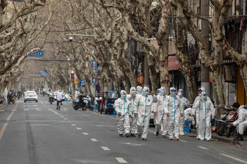 Quarantine workers in a neighborhood that had just been put under lockdown on March 15th last in response to rising Covid-19 cases in Shanghai, China. Photograph: Qilai Shen/New York Times