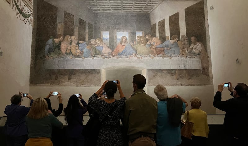 Tourists take photos with their phones of Leonardo da Vinci's  masterpiece Cenacolo (The Last Supper) located in Milan, in the refectory of the Dominican convent of Santa Maria delle Grazie. It is one of UNESCO's World Heritage sites. Photograph: Bryan O’Brien / The Irish Times

