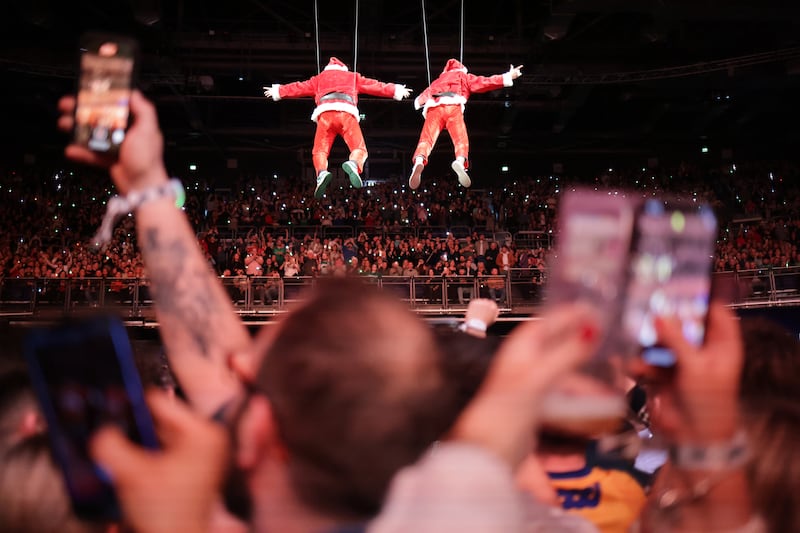 The 2 Johnnies arrive on aerials to perform their podcast to a massive crowd at the 3Arena in Dublin, Ireland. Photograph: Chris Maddaloni/The Irish Times
