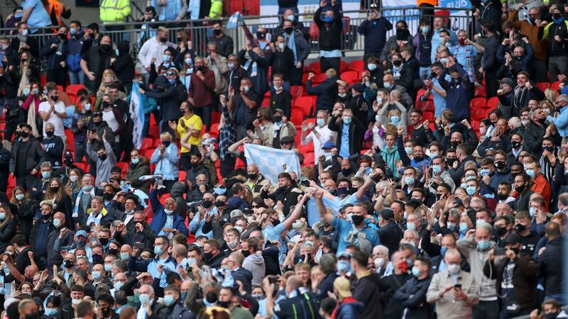 Man City fans celebrate during the League Cup final. Photo: Carl Recine/POOL/AFP via Getty Images