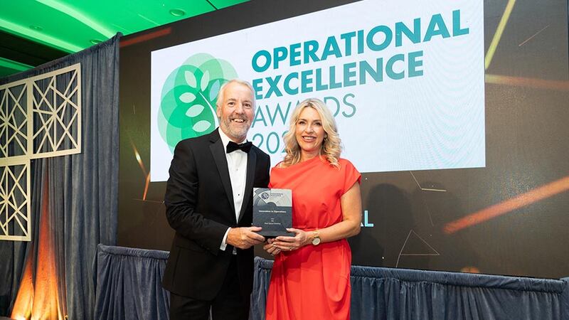 Brian Coll, awards judge, presents the innovation in operations to Sandra Murray, ISS