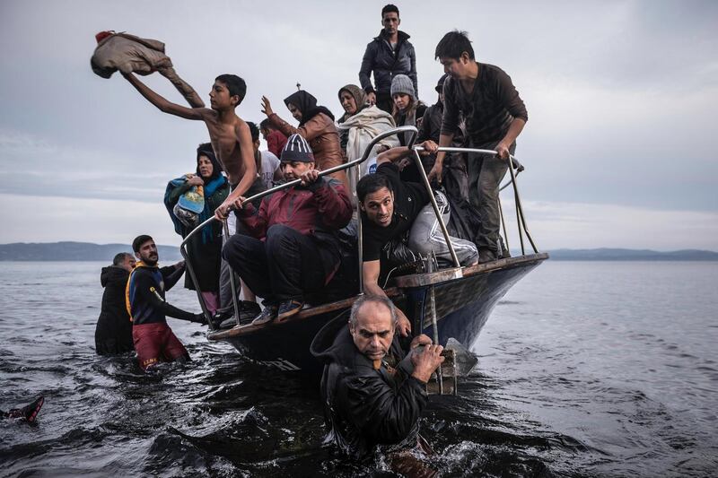 Migrants make land on a Turkish boat close to the village of Skala, on the Greek island of Lesbos on November 16th, 2015 Photograph: Sergey Ponomarev