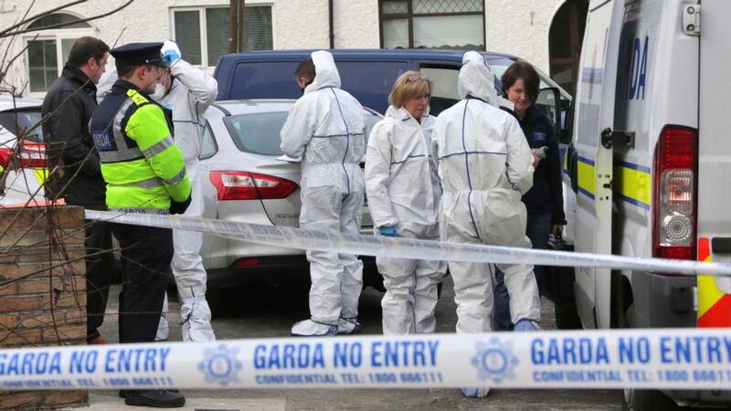 Gardaí  at the scene where the body of a man in his 40s was found in a house in Cabra. Photograph:  Collins Dublin.