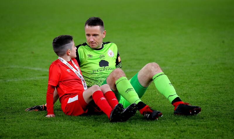 Shels’ goalkeeper Brendan Clarke with his son Zak after the FAI Cup final against Derry City at the Aviva Stadium, Dublin. Photograph: Ryan Byrne/Inpho