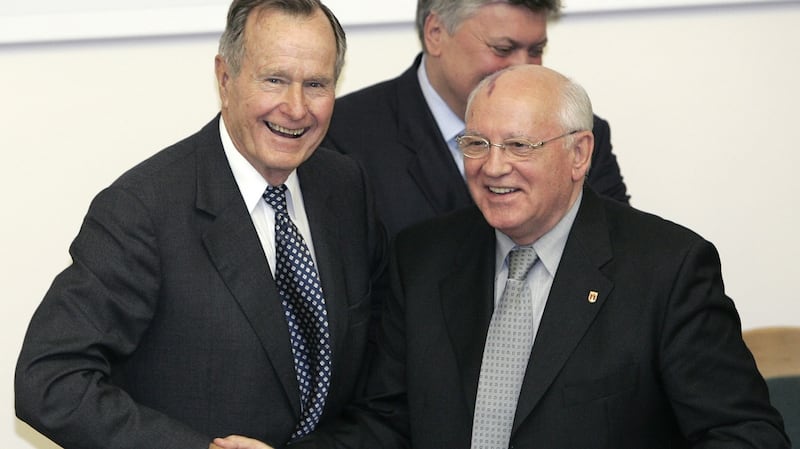 A  file photo from 2005 showing former US president George Bush (left) and the former Soviet leader Mikhail Gorbachev shaking hands. Photograph; AFP