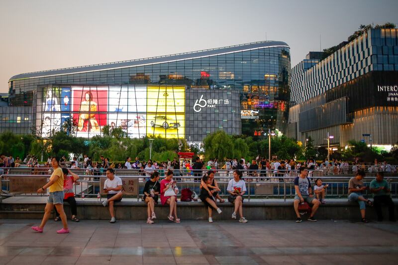 People sit along a park in Jinan. The service and retail sectors which employ a lot of young people were hit by China’s zero-Covid policy which ended last December. Photograph: Mark R Cristino/EPA