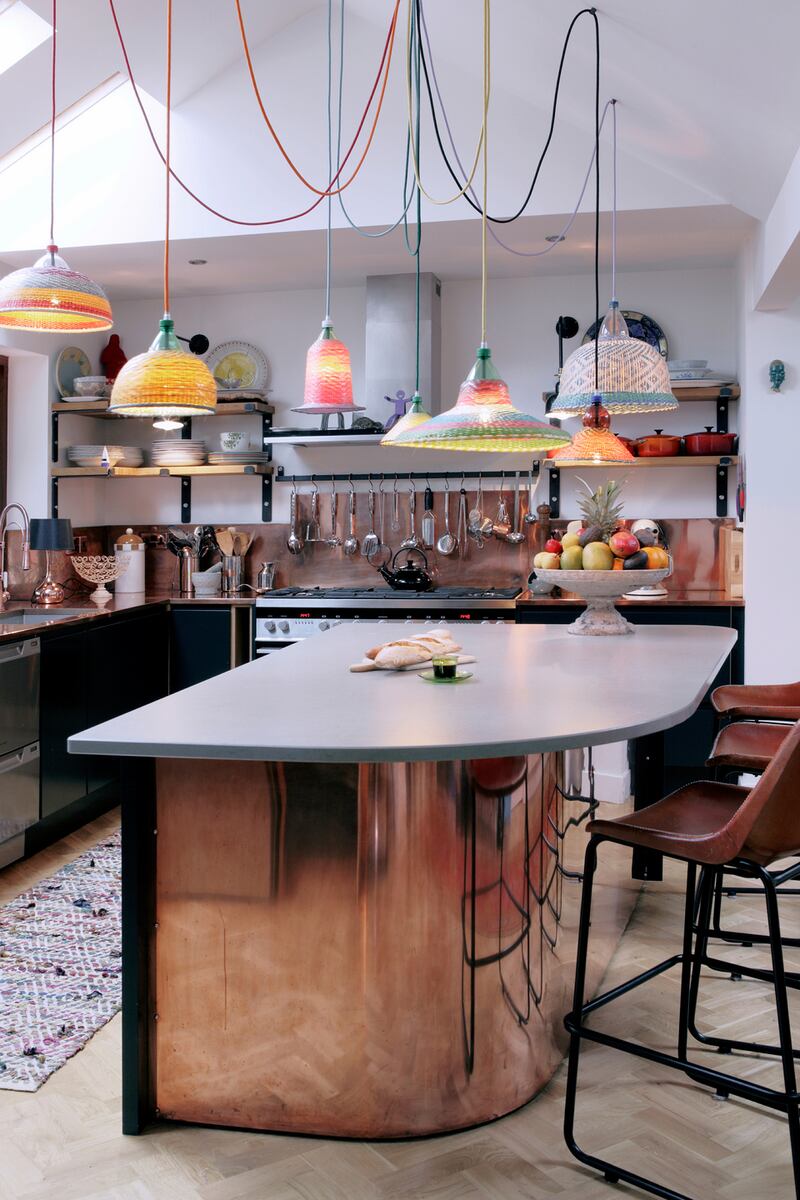 Photographed by Ruth Maria Murphy: a copper-clad kitchen with decorative woven-plastic lampshades