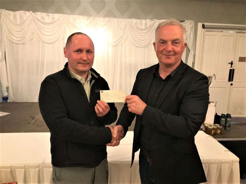 Antoni  Buczek (left) receiving a cheque for €500 as winner of the Charity  raffle from Gearoid Linnane CEO of Lee Strand Co-operative Creamery