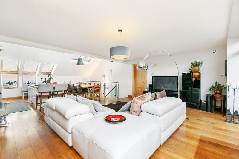 The living dining kitchen area is bathed in natural light