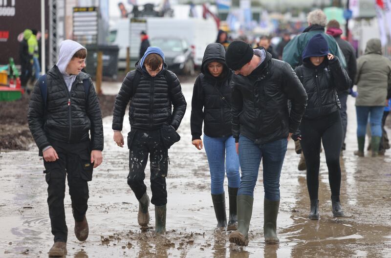 Attendees watch their step as they make their way around the site. Photograph: Dara Mac Dónaill/The Irish Times