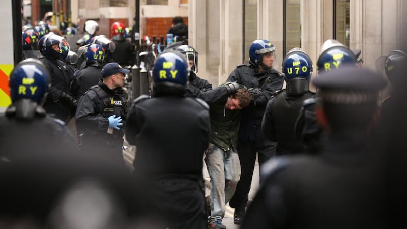 A man is detained by police on Golden Square, London during a protest  ahead of next week’s G8 summit in Northern Ireland. Photograph: Oli Scarff/Getty Images