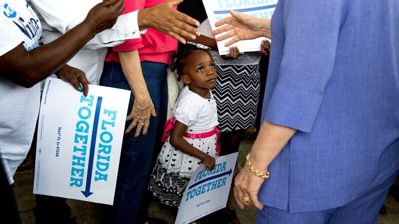 A child watches as Hillary Clinton visits an early voting location in Pompano Beach, Florida. The rancour of the US presidential election has spilled into classrooms and schoolyards. Photograph: Doug Mills/The New York Times