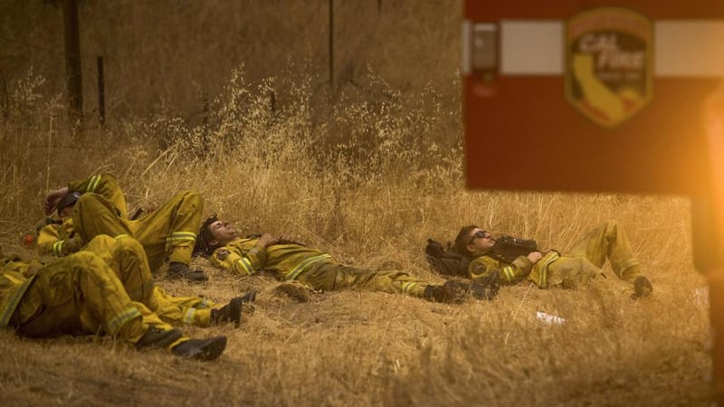 Cal Fire Santa Clara firefighters rest after battling the Valley Fire in Middletown, California. Photograph: Noah Berger/Reuters