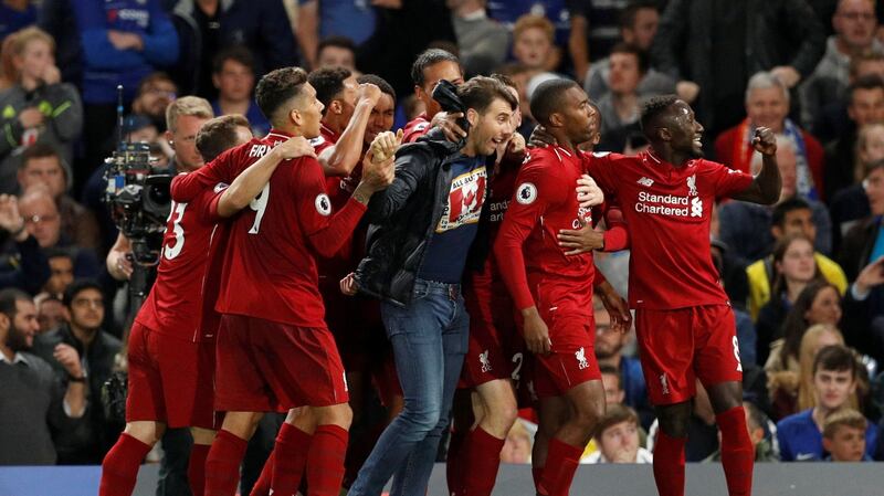 A supporter joins in as Liverpool’s Daniel Sturridge celebrates scoring the equalising goal with his team-mates at Stamford Bridge. Photograph: John Sibley/Action Images via Reuters