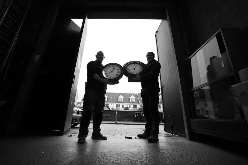 Bernard Phelan and Keith 'Nonnors' O'Connor of RJ Keighery bring clocks to the back door for collection by buyers. All photographs: Bryan O’Brien