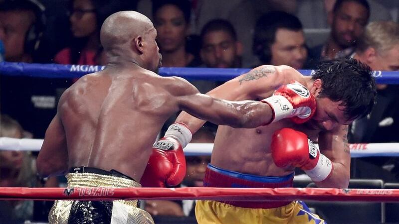 Floyd Mayweather  throws a punch at Manny Pacquiao during their welterweight unification championship fight. Photograph: Getty