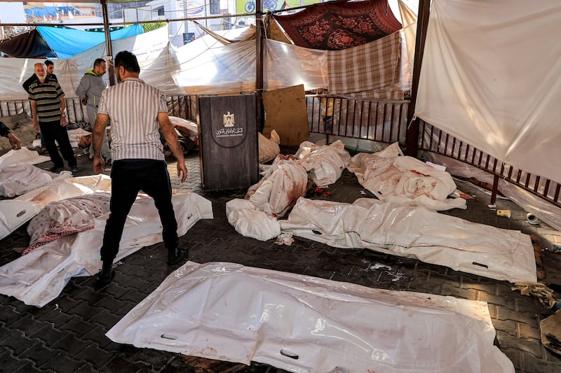 People gather by the wrapped bodies of victims who died in an overnight blast at the Ahli-Arab hospital in central Gaza on October 18th. Photograph: MAHMUD HAMS/AFP via Getty Images