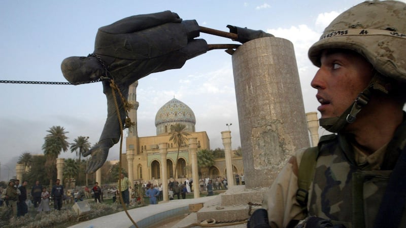 A US marine watches as a statue of Saddam Hussein is toppled in central Baghdad after the US-led invasion in 2003. Photograph: Goran Tomasevic/Reuters