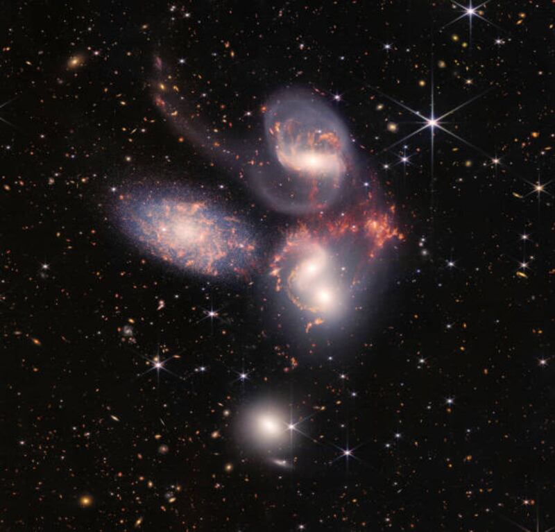 The James Webb Space Telescope reveals Stephans Quintet, a visual grouping of five galaxies, in a new light on July 12, 2022 in space. This enormous mosaic is Webb's largest image to date, covering about one-fifth of the Moons diameter. The information from Webb provides new insights into how galactic interactions may have driven galaxy evolution in the early universe.  (Photo by NASA, ESA, CSA, and STScI via Getty Images)